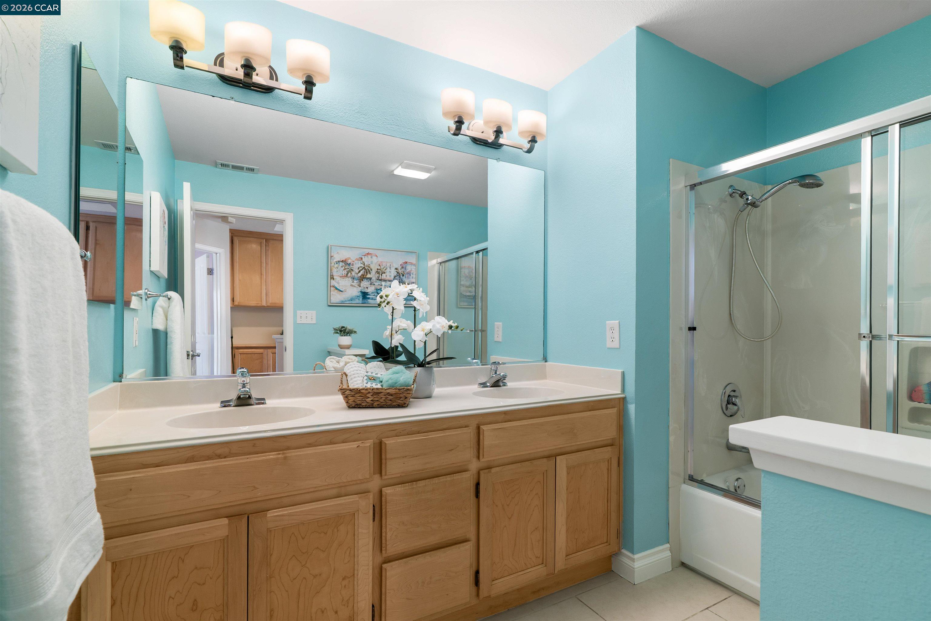 7151 Briza Loop San Ramon, CA 94582 - Photo 20 of 29 a bathroom with a double vanity sink mirror and toilet