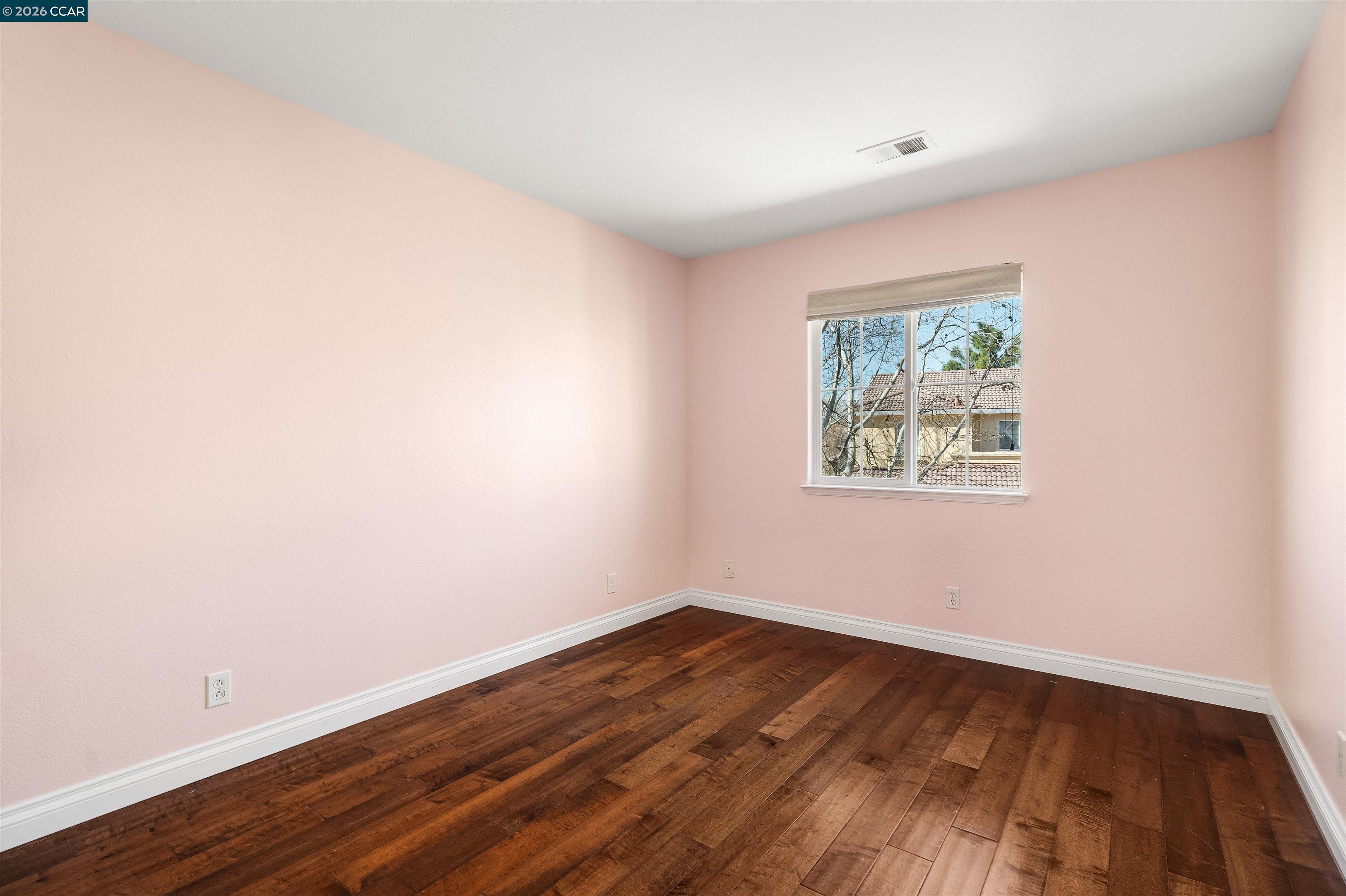 7151 Briza Loop San Ramon, CA 94582 - Photo 21 of 29 an empty room with wooden floor and window