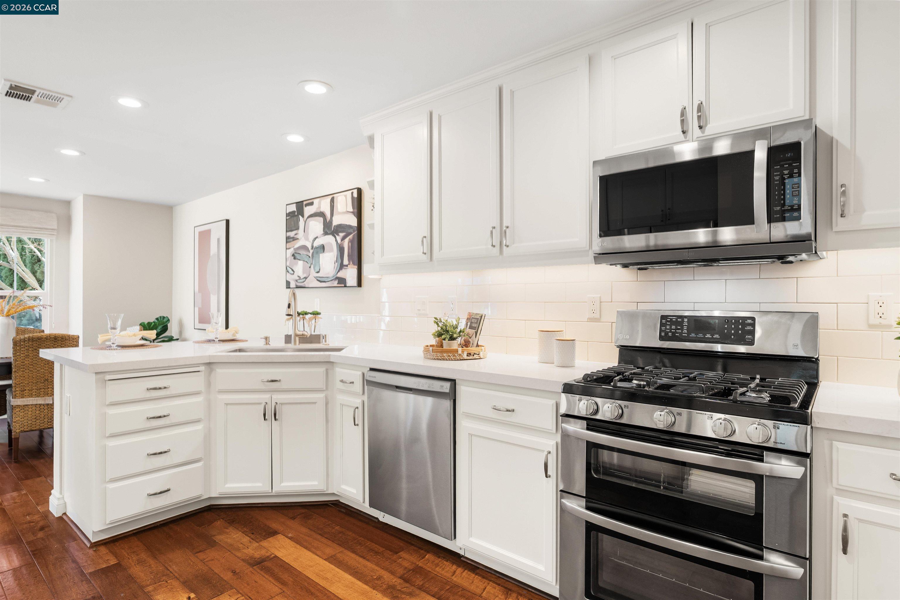 7151 Briza Loop San Ramon, CA 94582 - Photo 8 of 29 a kitchen with stainless steel appliances a stove microwave and cabinets