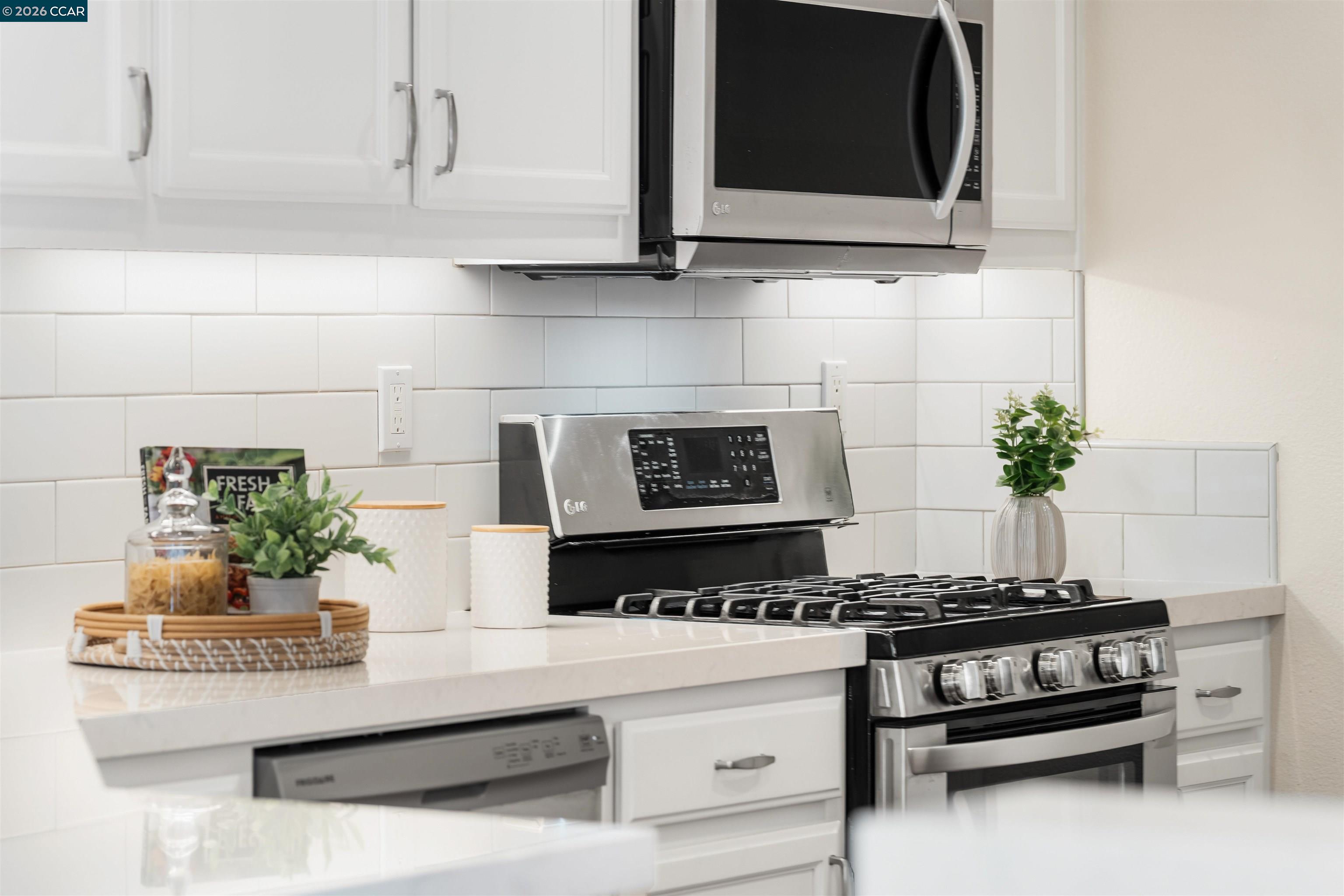 7151 Briza Loop San Ramon, CA 94582 - Photo 9 of 29 a kitchen with a stove and a microwave