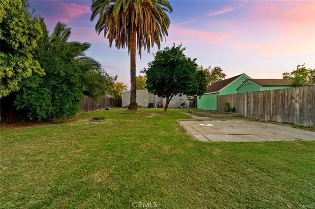 a backyard of a house with table and chairs