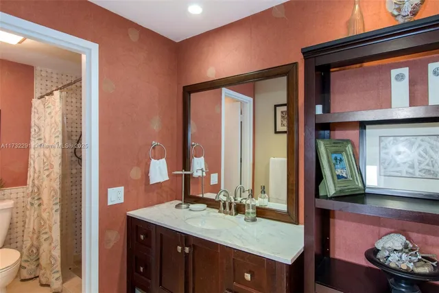 a bedroom with two bed and a flat tv screen on dresser