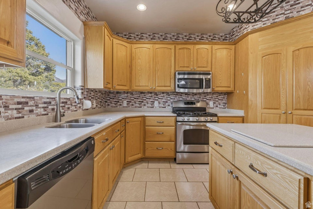 1001 Pine Valley Road Pine Valley, UT 84781 - Photo 19 of 49 Kitchen with stainless steel appliances, light tile patterned floors, light wood finish cabinets, light stone countertops, and decorative backsplash