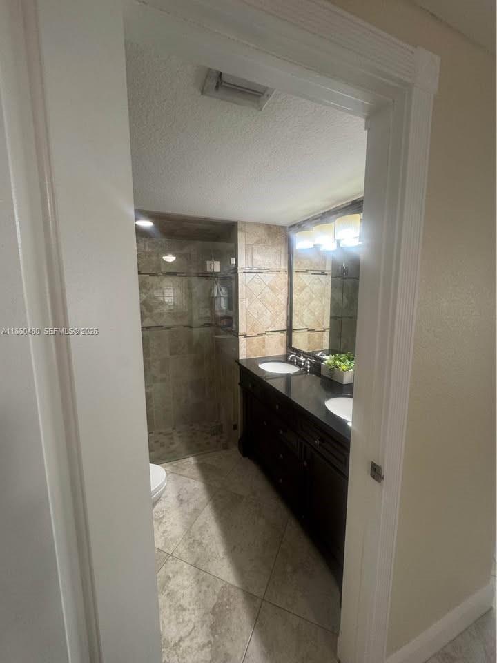 3781 Riedel Avenue Palm Springs, FL 33461 - Photo 12 of 25 a bathroom with a glass door shower