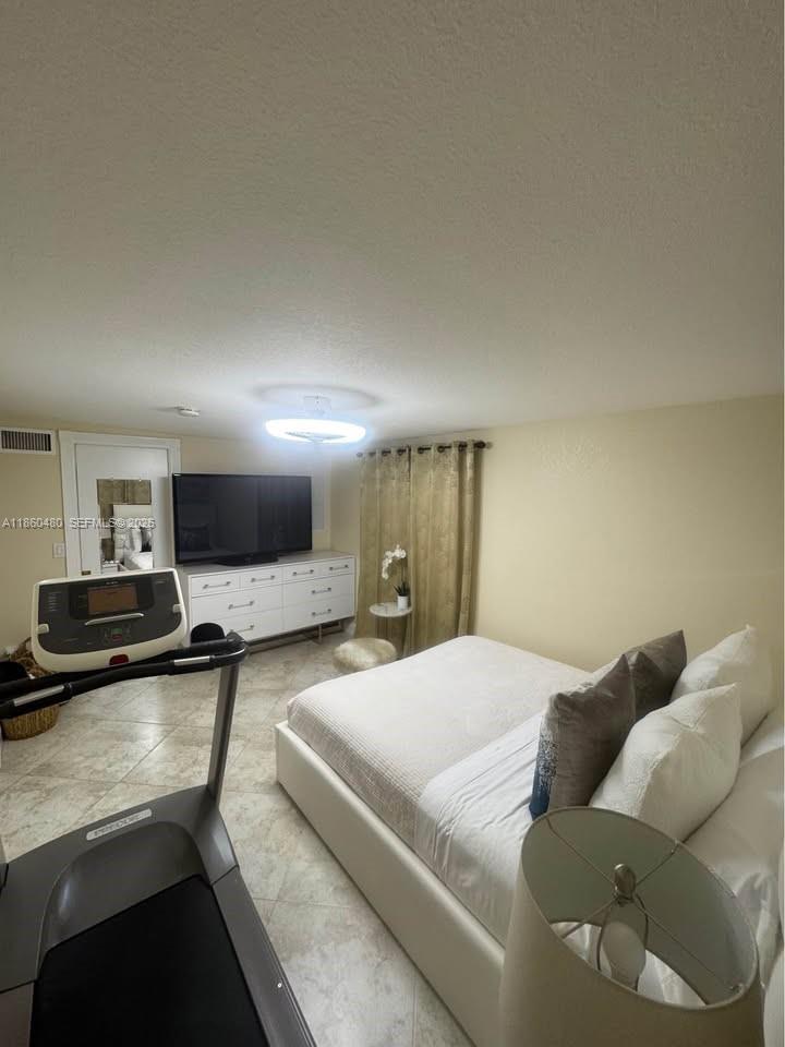 3781 Riedel Avenue Palm Springs, FL 33461 - Photo 15 of 25 a bedroom with a bed and a view of kitchen