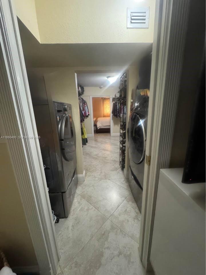 3781 Riedel Avenue Palm Springs, FL 33461 - Photo 17 of 25 a view of a hallway with washer and dryer