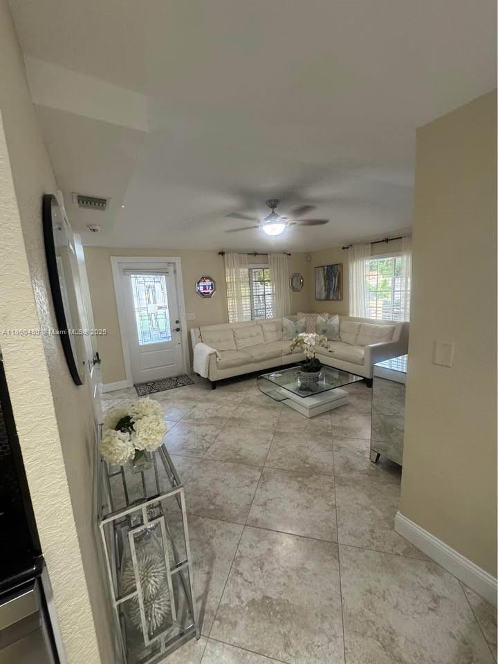 3781 Riedel Avenue Palm Springs, FL 33461 - Photo 2 of 21 a living room with furniture a window and appliances