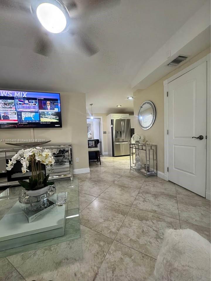 3781 Riedel Avenue Palm Springs, FL 33461 - Photo 21 of 21 a living room with furniture and a flat screen tv