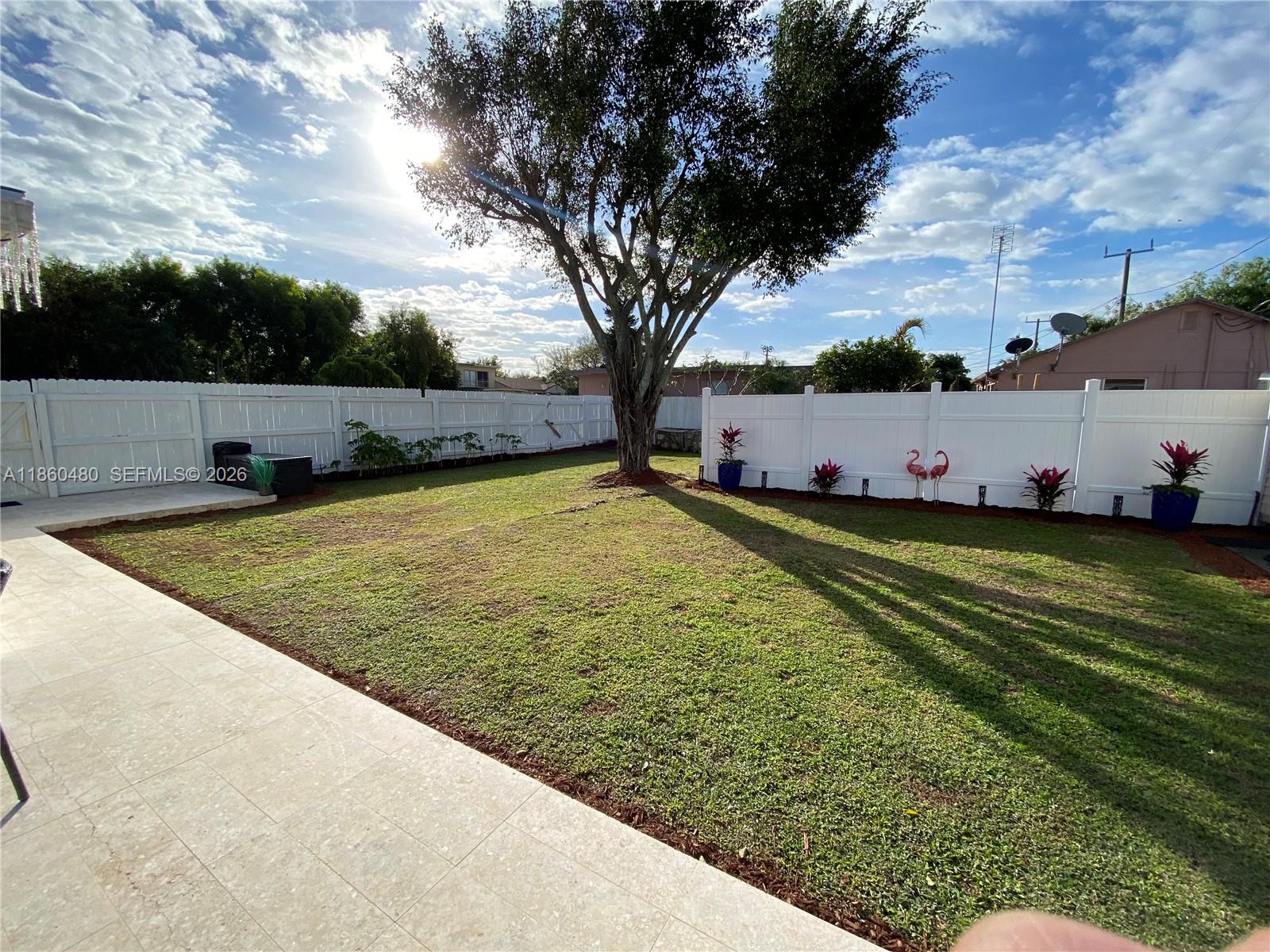 3781 Riedel Avenue Palm Springs, FL 33461 - Photo 23 of 25 a view of a swimming pool and a yard
