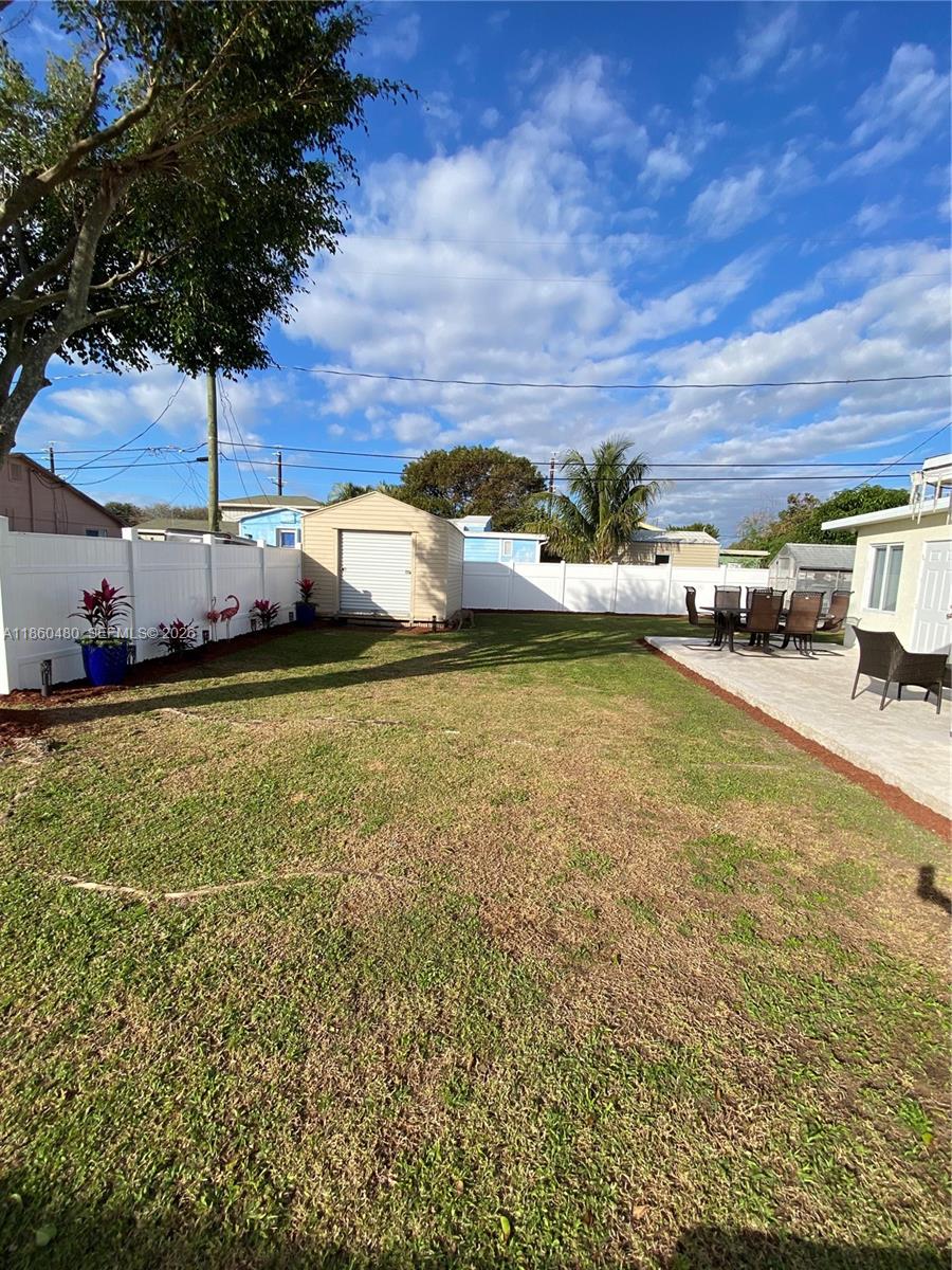 3781 Riedel Avenue Palm Springs, FL 33461 - Photo 24 of 25 a view of a swimming pool and a yard