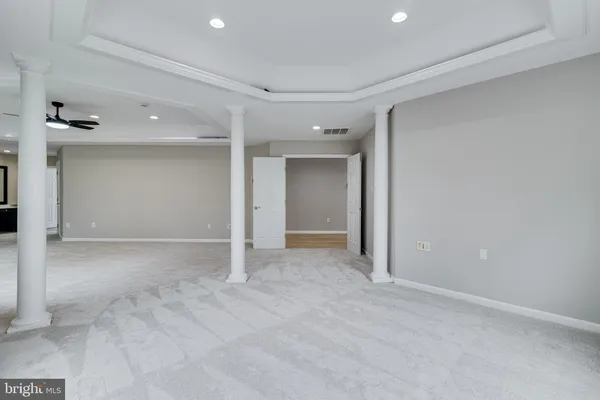a view of an empty room with a fireplace and a window