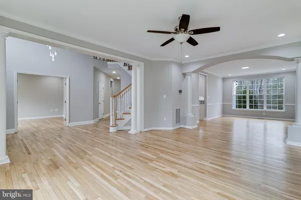 a view of an empty room with wooden floor