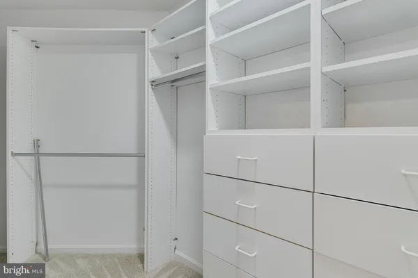 a view of an empty room with a ceiling fan