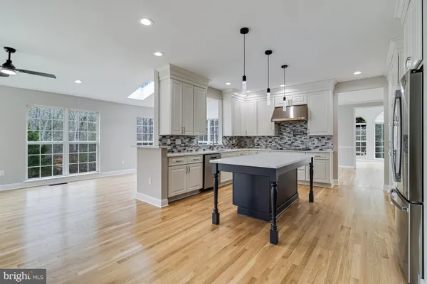 a view of empty room with wooden floor and windows