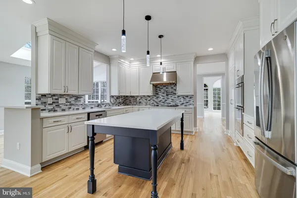 a spacious bathroom with a tub sink and mirror