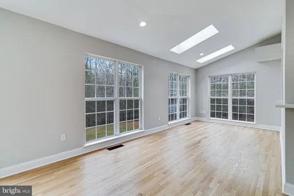 a spacious bathroom with a double vanity sink a large mirror and a bathtub