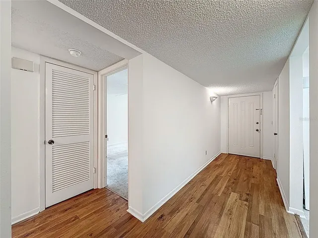 a view of a room with wooden floor