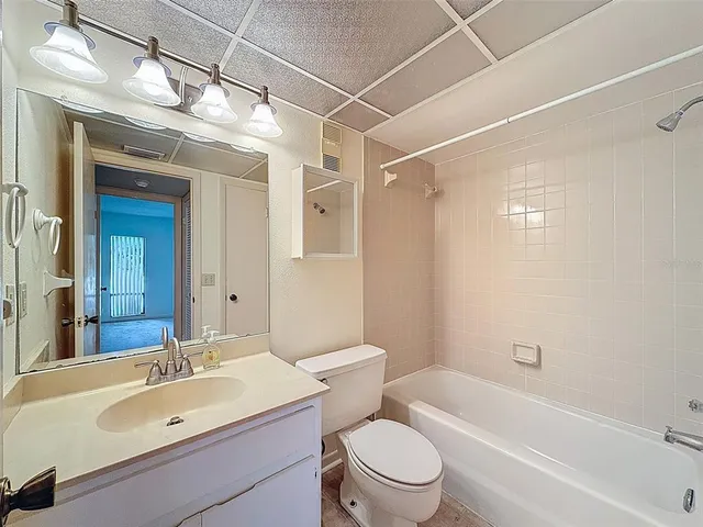 a bathroom with a sink mirror toilet and bathtub