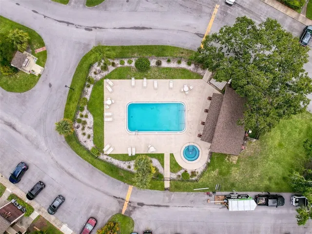 an aerial view of a house with a garden and a sign
