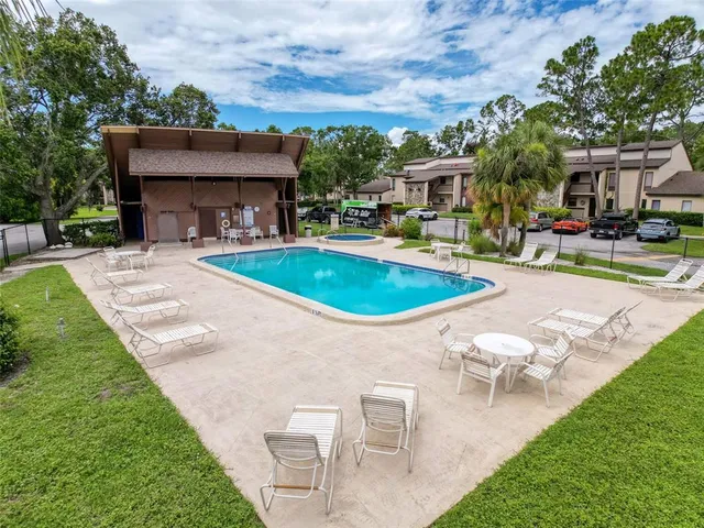 a swimming pool with outdoor seating and yard