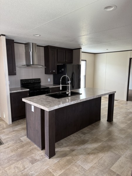 20410 Telge Road, Unit 11 Tomball, TX 77377 - Photo 14 of 30 a kitchen with stainless steel appliances granite countertop a stove a sink and a refrigerator