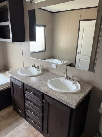 a bathroom with a granite countertop sink and a vanity