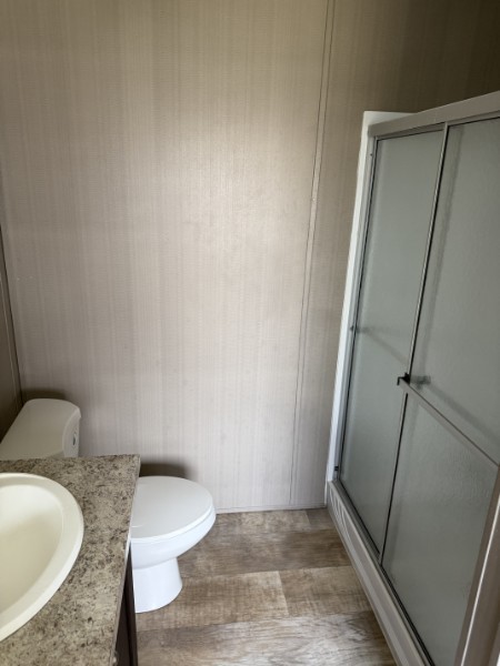 20410 Telge Road, Unit 11 Tomball, TX 77377 - Photo 22 of 30 a bathroom with a granite countertop sink and a vanity