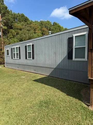 a backyard of a house with large trees