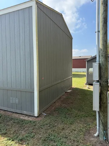 a view of an house with backyard and sitting area