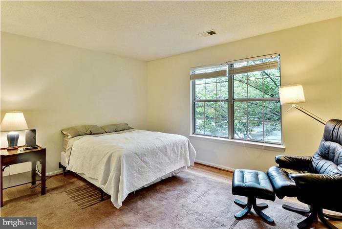 12009 Golf Ridge Court, Unit 202 Fairfax, VA 22033 - Photo 11 of 30 a bedroom with a bed window and lamp