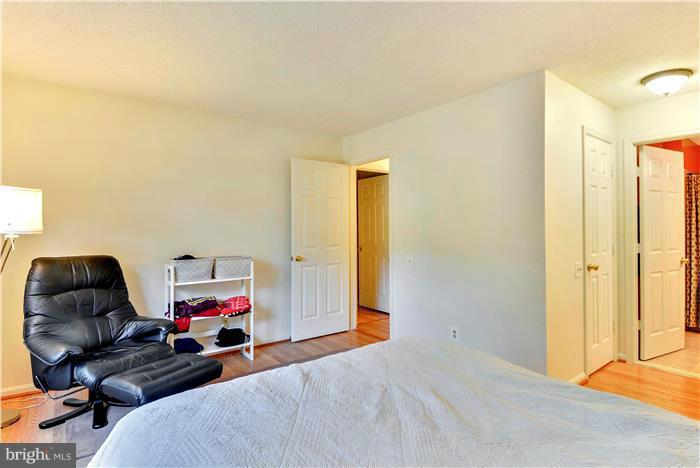12009 Golf Ridge Court, Unit 202 Fairfax, VA 22033 - Photo 12 of 30 a bed room with a bed and a chair