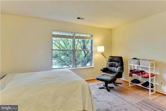 12009 Golf Ridge Court, Unit 202 Fairfax, VA 22033 - Photo 13 of 30 a bedroom with a bed and a window
