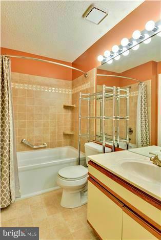 12009 Golf Ridge Court, Unit 202 Fairfax, VA 22033 - Photo 14 of 30 a bathroom with a sink mirror toilet and bathtub