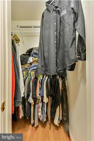 12009 Golf Ridge Court, Unit 202 Fairfax, VA 22033 - Photo 15 of 30 a view of walk in closet with clothes and shoes