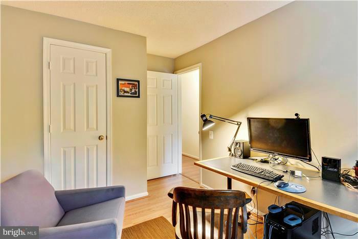 12009 Golf Ridge Court, Unit 202 Fairfax, VA 22033 - Photo 17 of 30 a view of a livingroom with furniture and a flat screen tv