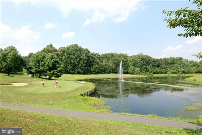 12009 Golf Ridge Court, Unit 202 Fairfax, VA 22033 - Photo 25 of 30 a view of a swimming pool with a yard and large trees
