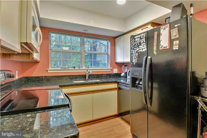 12009 Golf Ridge Court, Unit 202 Fairfax, VA 22033 - Photo 10 of 30 a kitchen with a sink and a refrigerator