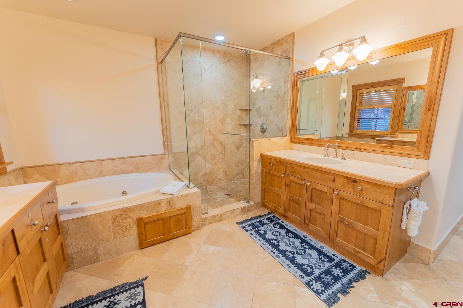 14 Hunter Hill Road, Unit A208 Crested Butte, CO 81225 - Photo 11 of 35 a bathroom with a tub sink and mirror