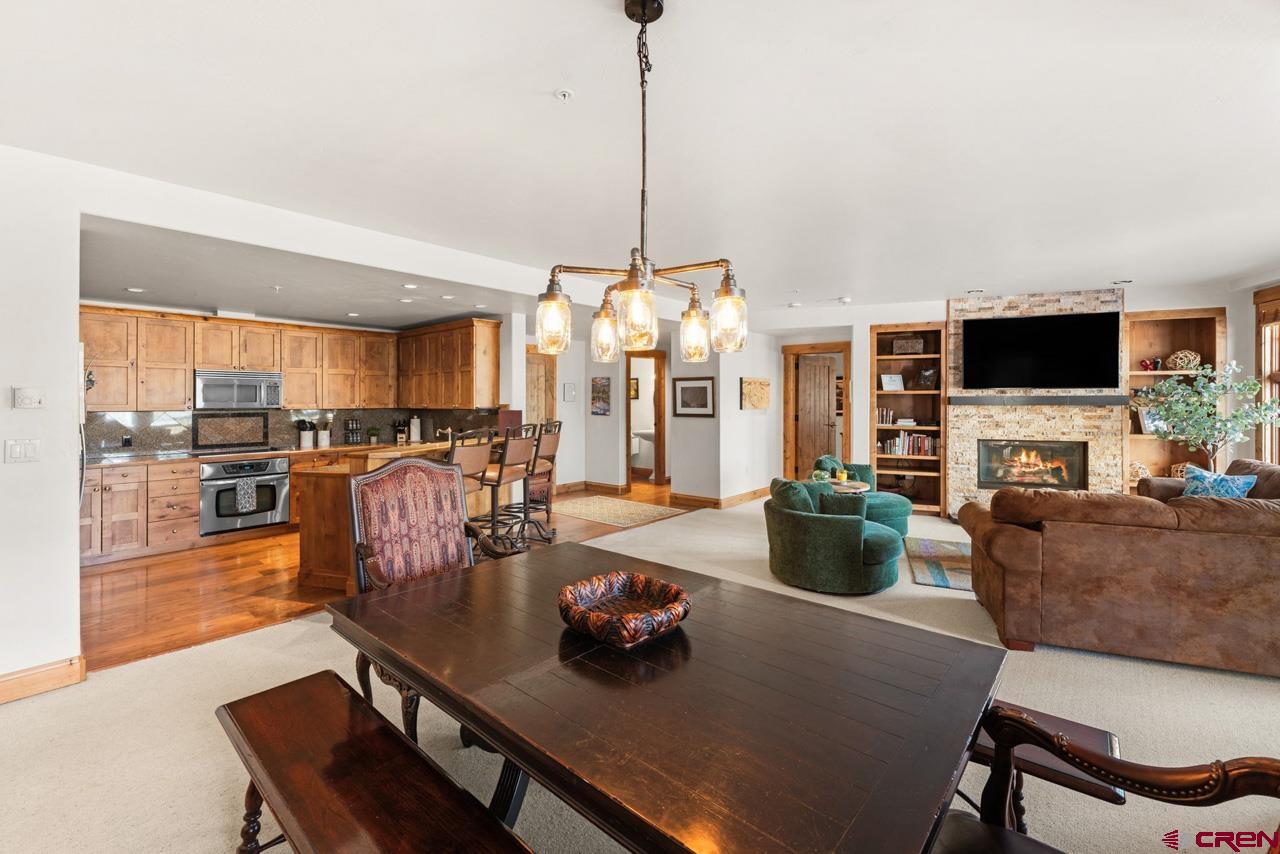 14 Hunter Hill Road, Unit A208 Crested Butte, CO 81225 - Photo 12 of 43 a view of a dining room with furniture window and wooden floor