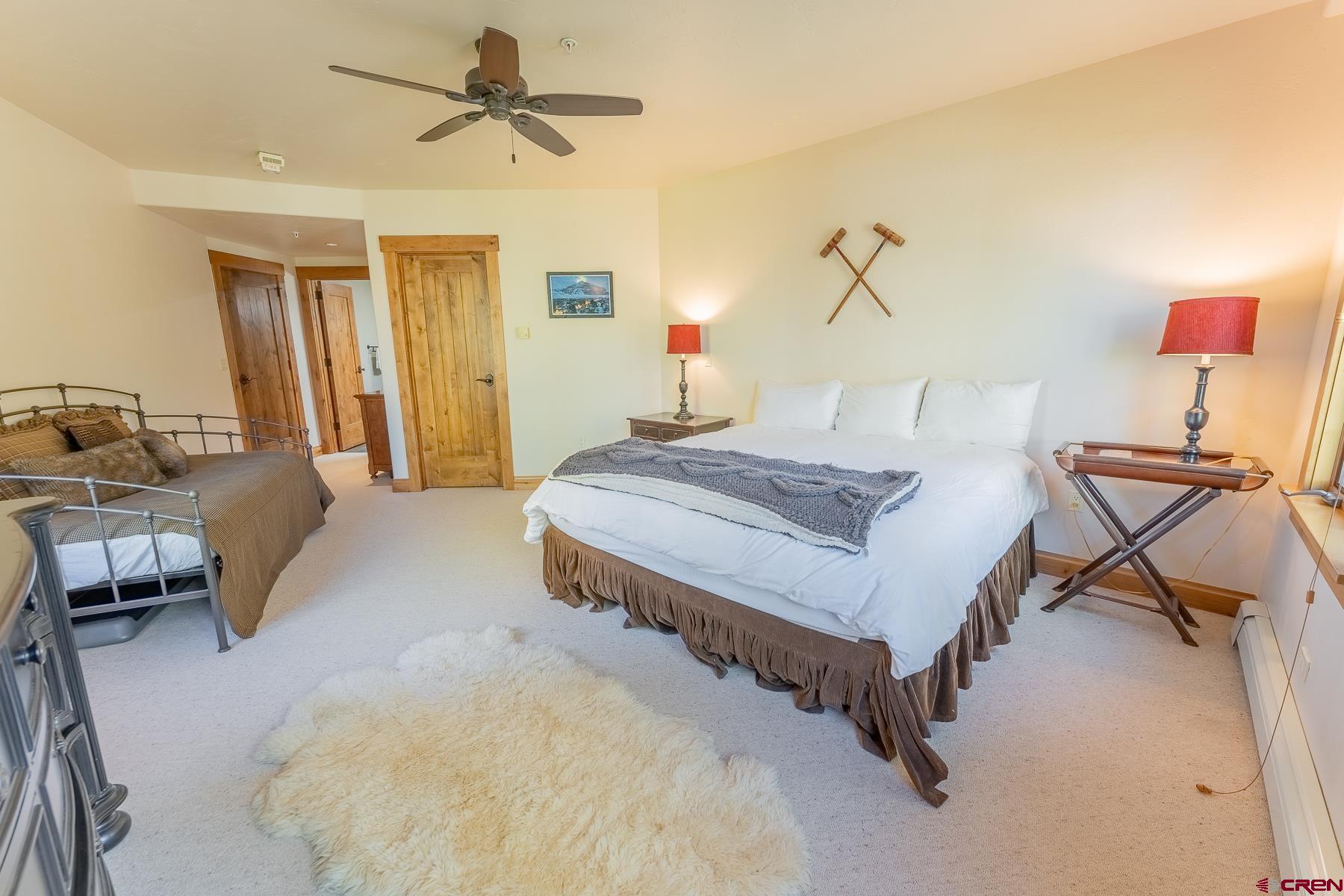 14 Hunter Hill Road, Unit A208 Crested Butte, CO 81225 - Photo 12 of 35 a bedroom with a bed and a chandelier