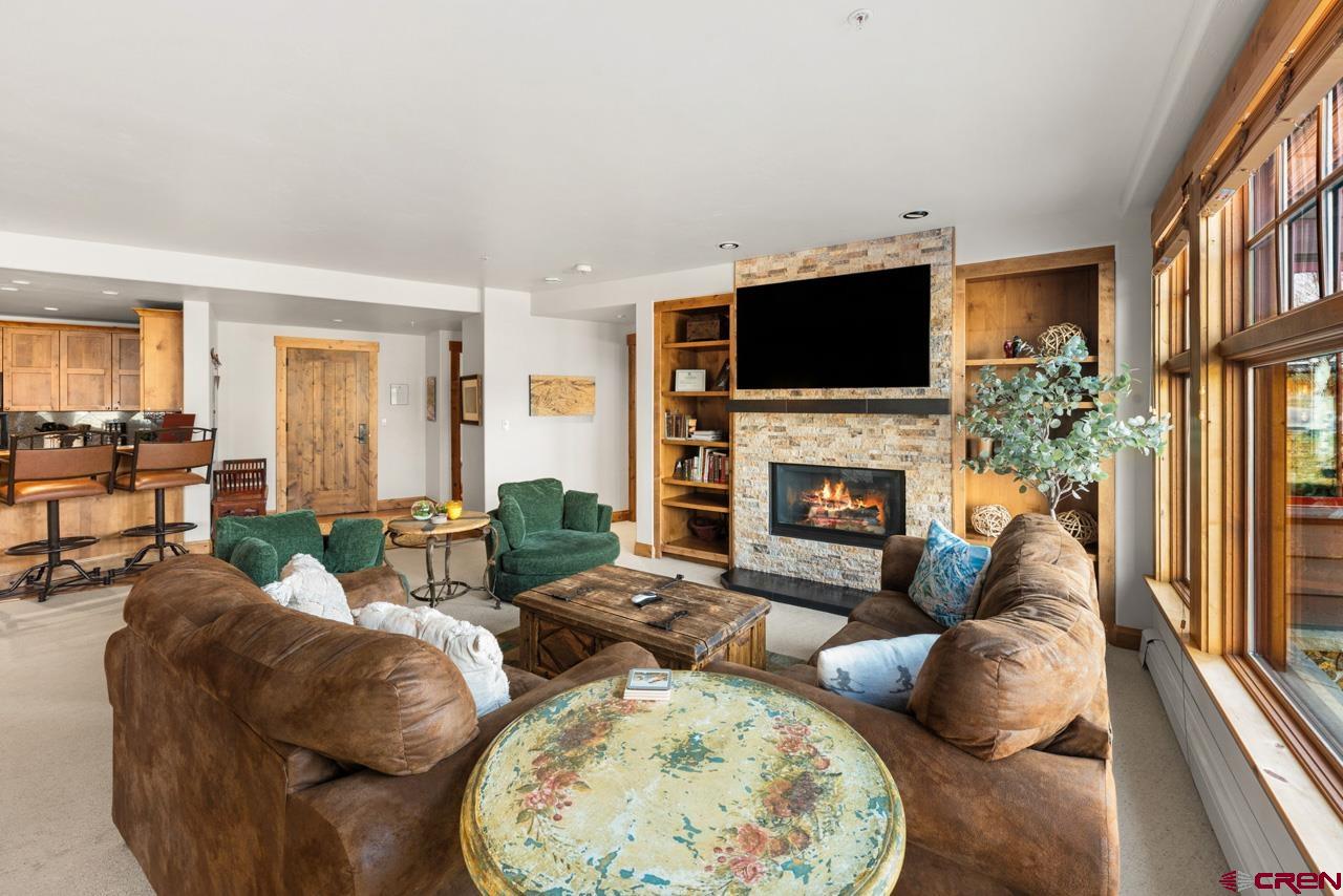 14 Hunter Hill Road, Unit A208 Crested Butte, CO 81225 - Photo 15 of 43 a living room with furniture fireplace and flat screen tv