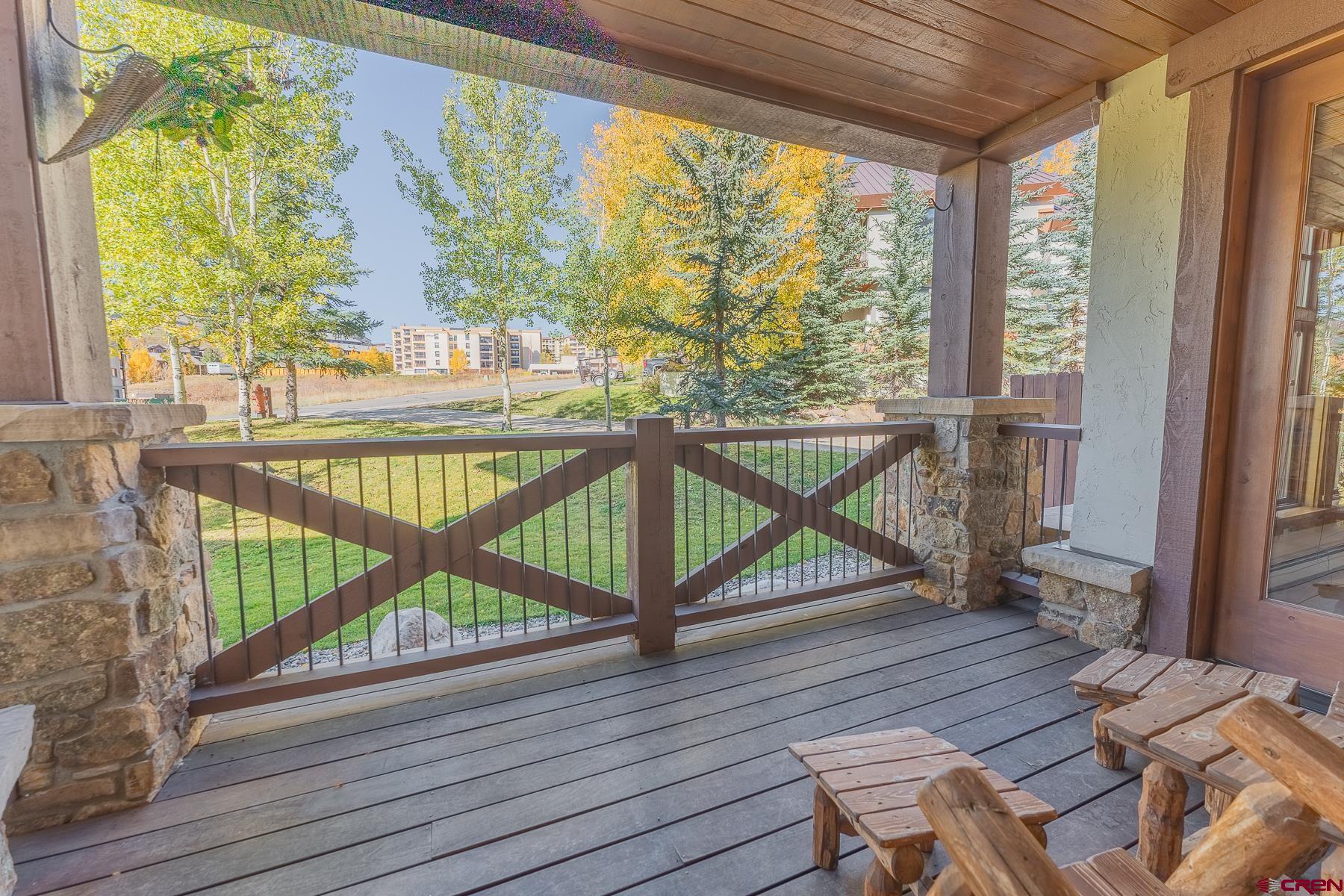 14 Hunter Hill Road, Unit A208 Crested Butte, CO 81225 - Photo 17 of 43 a view of a balcony with wooden floor and chairs