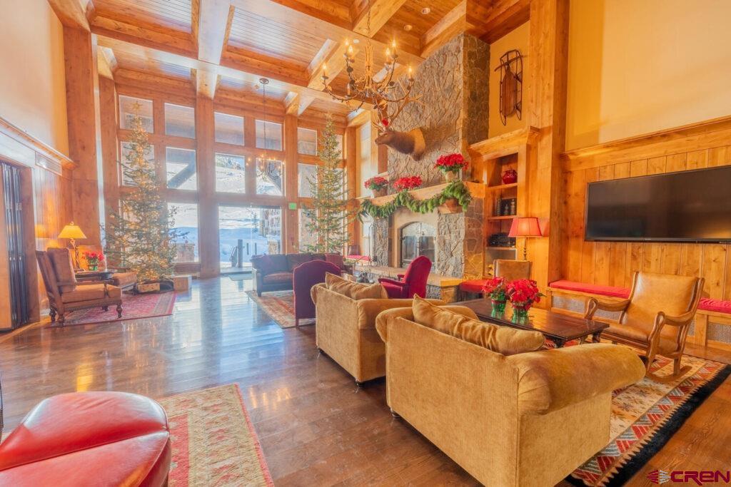 14 Hunter Hill Road, Unit A208 Crested Butte, CO 81225 - Photo 18 of 35 a living room filled with furniture and a flat screen tv