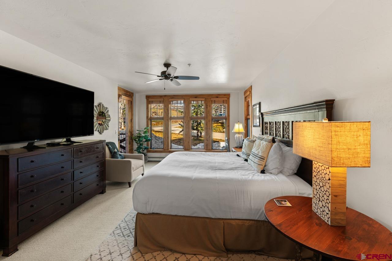 14 Hunter Hill Road, Unit A208 Crested Butte, CO 81225 - Photo 20 of 43 a bedroom with a bed and a flat screen tv