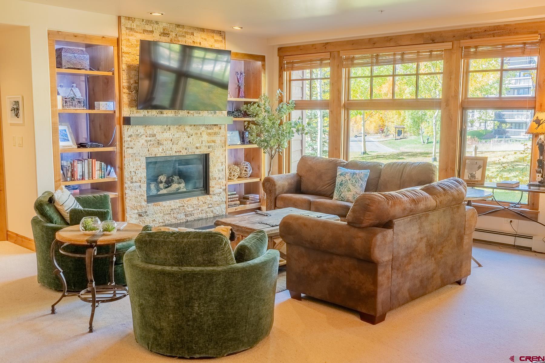 14 Hunter Hill Road, Unit A208 Crested Butte, CO 81225 - Photo 2 of 35 a living room with furniture and a fireplace