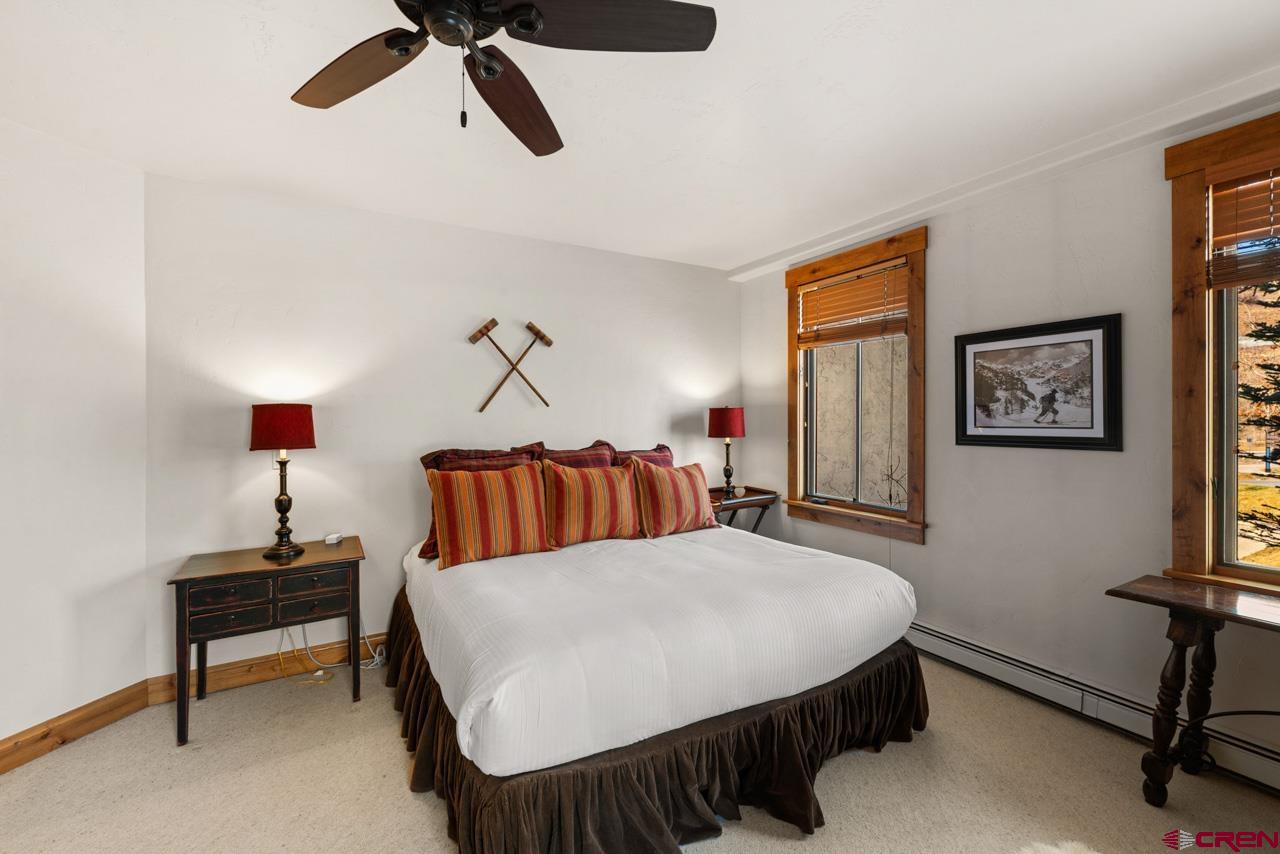 14 Hunter Hill Road, Unit A208 Crested Butte, CO 81225 - Photo 31 of 43 a bedroom with a bed and a chandelier