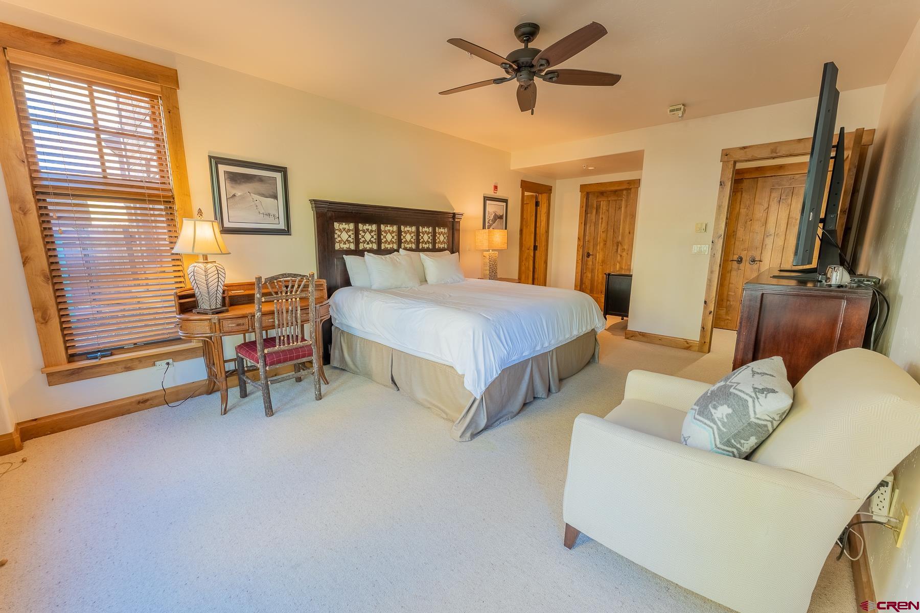 14 Hunter Hill Road, Unit A208 Crested Butte, CO 81225 - Photo 32 of 35 a bedroom with a bed and a chandelier