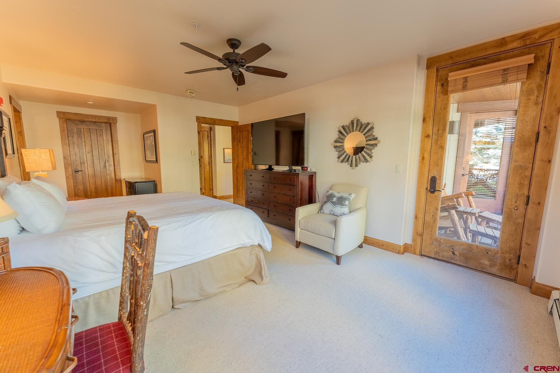14 Hunter Hill Road, Unit A208 Crested Butte, CO 81225 - Photo 33 of 35 a bedroom with a balcony a bed and a chandelier
