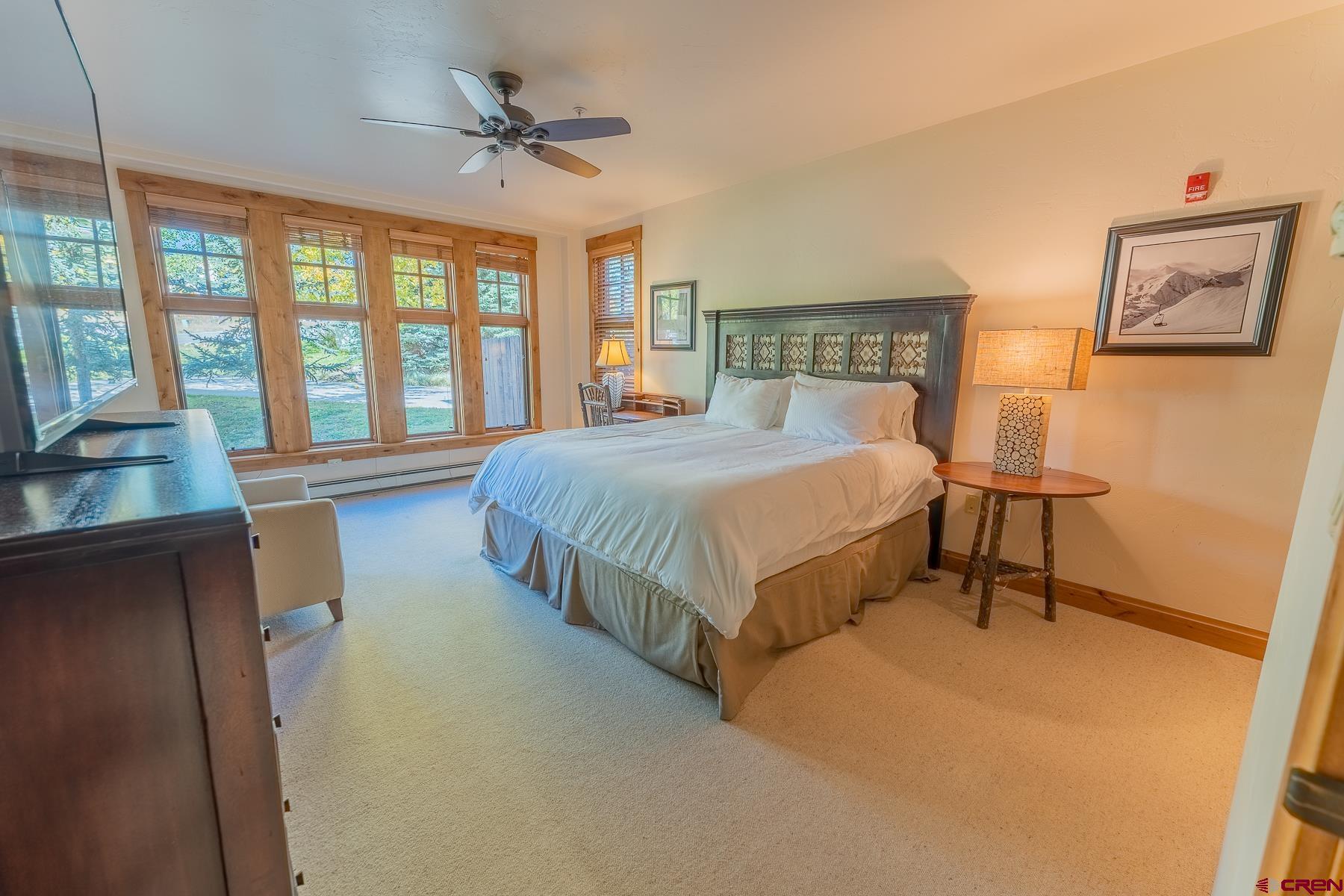 14 Hunter Hill Road, Unit A208 Crested Butte, CO 81225 - Photo 34 of 35 a bedroom with a bed and a chandelier