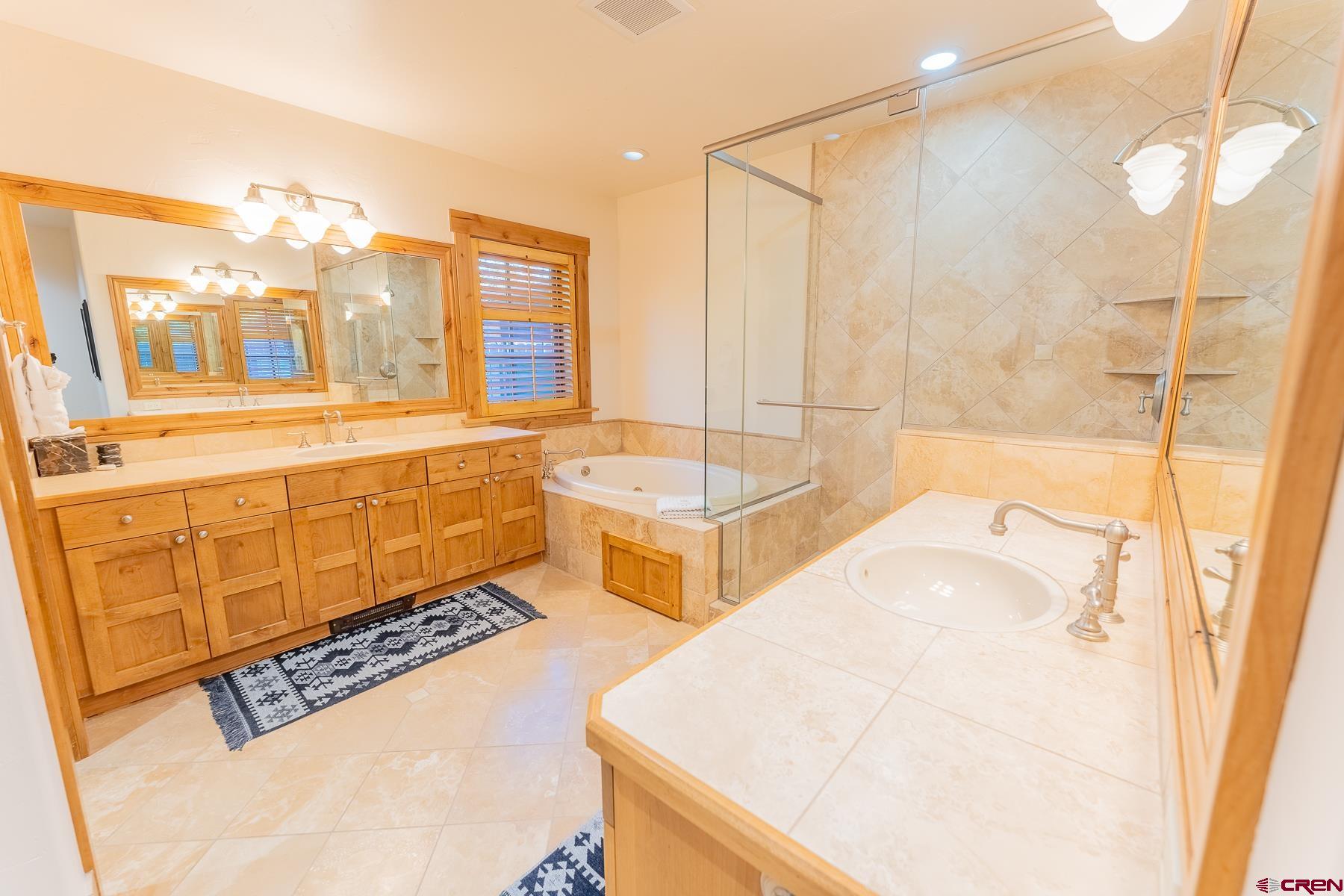 14 Hunter Hill Road, Unit A208 Crested Butte, CO 81225 - Photo 35 of 35 a spacious bathroom with a tub sink and mirror